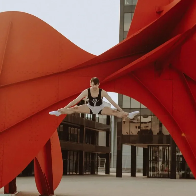 young athlete trampolining in front of the Calder sculpture