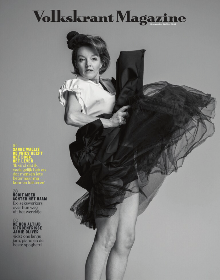 Black and white magazine cover of Volkskrant Magazine featuring a woman in a tulle skirt and white blouse, holding a black jacket, with a serious expression.