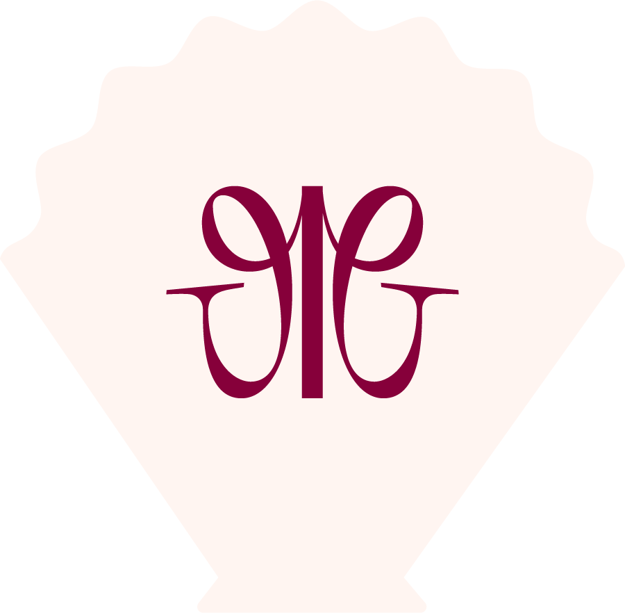 A diamond-shaped wedding invitation with a maroon monogram in the center, featuring stylized initials 'J' and 'G' intertwined.