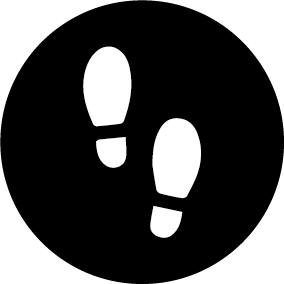 Wandelingenschoenen icon binnen een zwarte cirkel