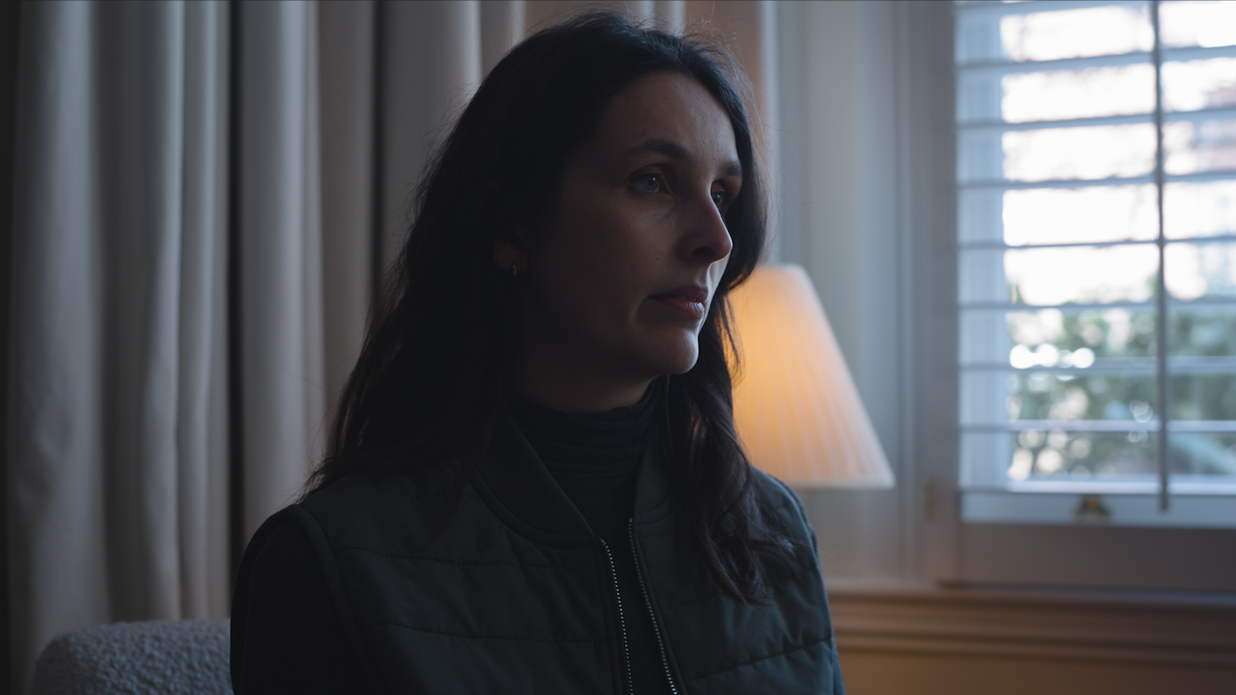 Cinematic production still of a female actor in character, filmed in natural light for a character trailer produced for a book-to-screen campaign by Gunpowder House Productions