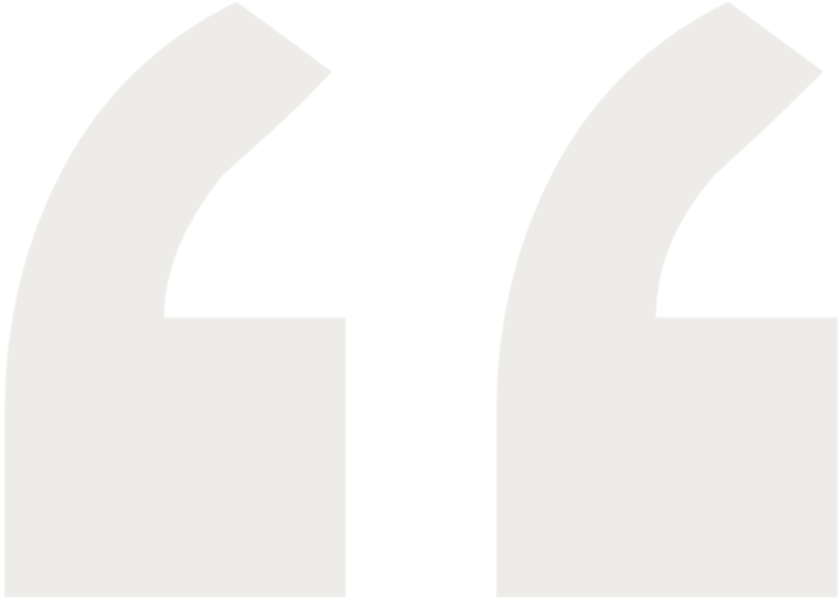 Close-up of a black quotation mark icon on a white background