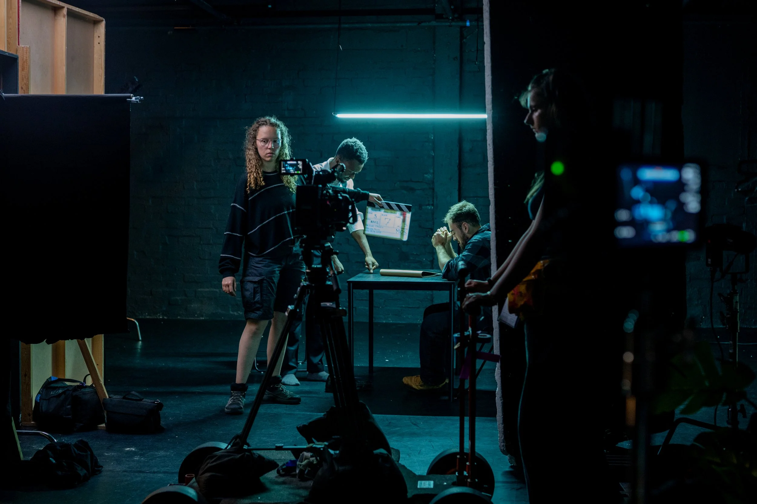 Film production crew with camera and clapperboard on a studio set during a book advertising TVC shoot managed by Gunpowder House Productions for broadcast clearance on UK television