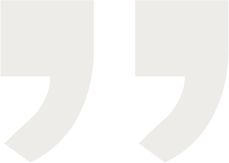 Close-up of black quotation marks on a white background.