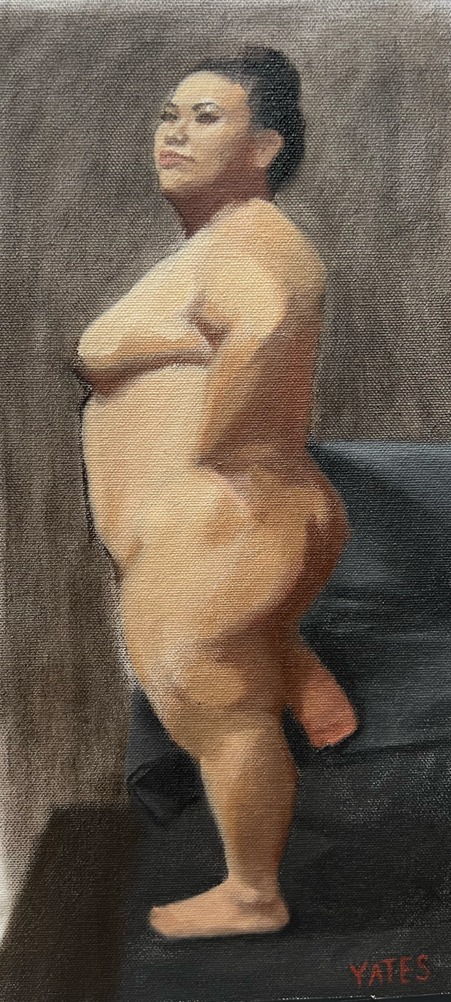 Nude woman standing in front of a textured brown background, signed by Yates in the bottom right corner.