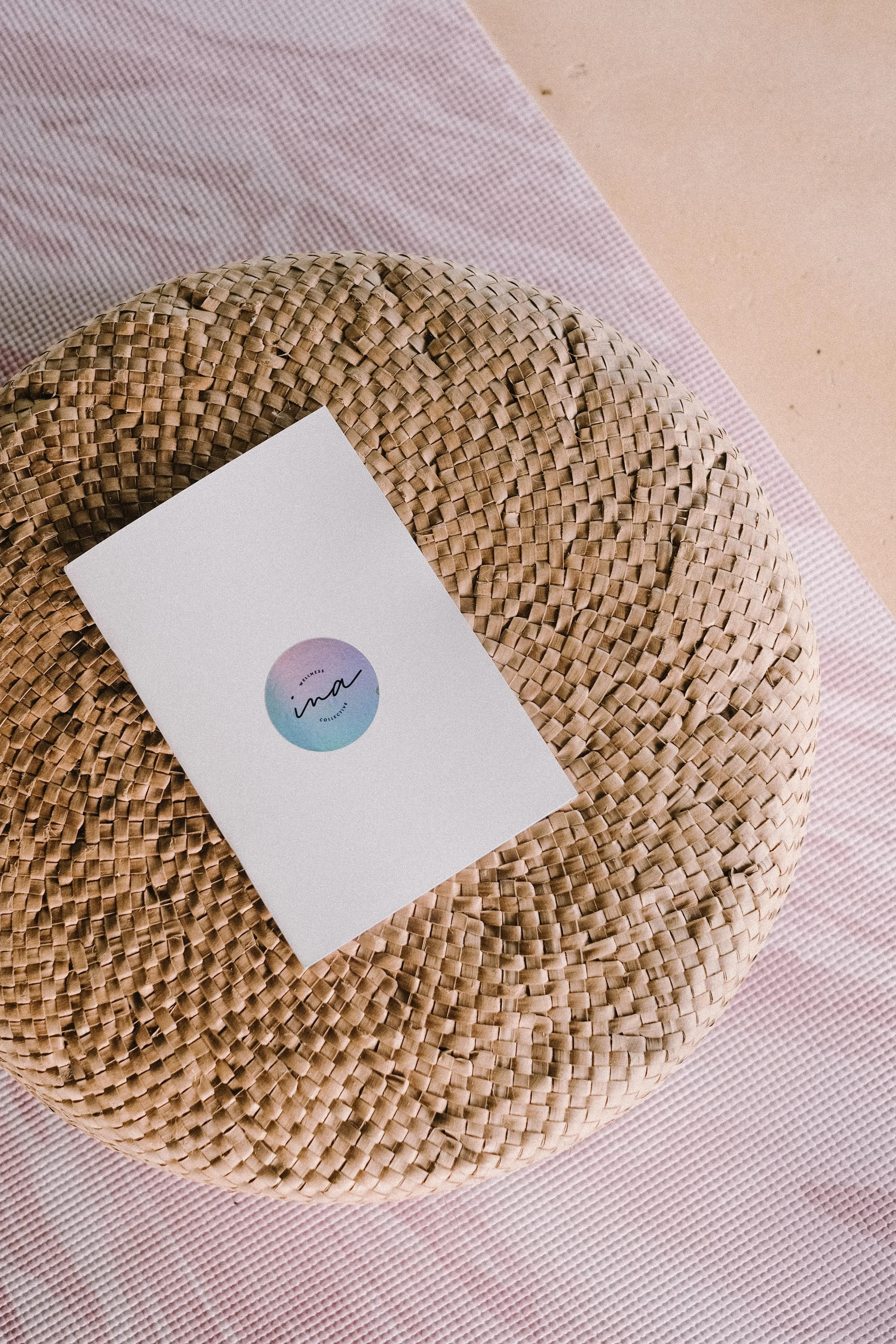 Group of people walking on a wooden pathway surrounded by dense green tropical foliage, with some people wearing hats.