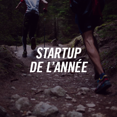 Two people running or hiking in the forest, with the text "STARTUP OF THE YEAR" superimposed.