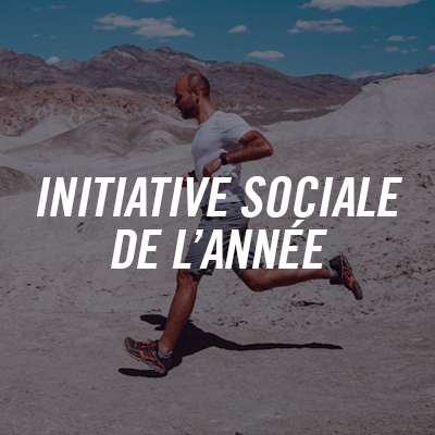 A man runs through a mountain desert with a blue sky, wearing a white t-shirt and gray shorts, with the text 'Social Initiative of the Year' superimposed.