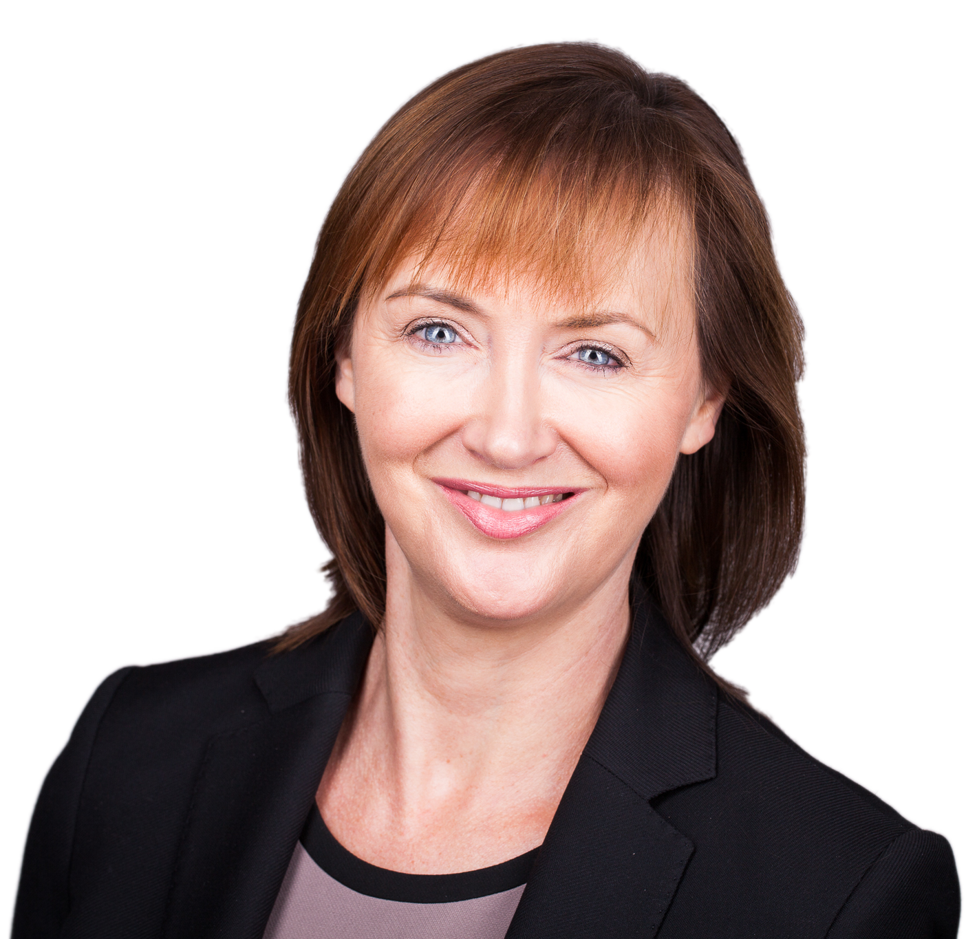 Close-up portrait of a smiling middle-aged woman with shoulder-length brown hair and blue eyes, wearing a black blazer over a light-colored top.