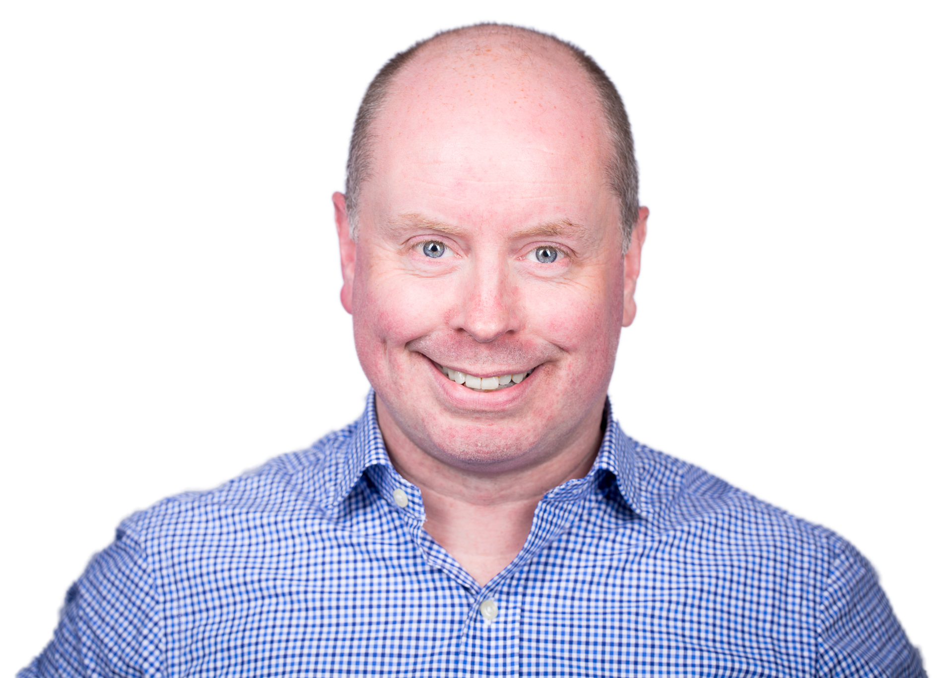 A smiling middle-aged man with short hair, light skin, wearing a blue and white checkered shirt, posed against a neutral background.