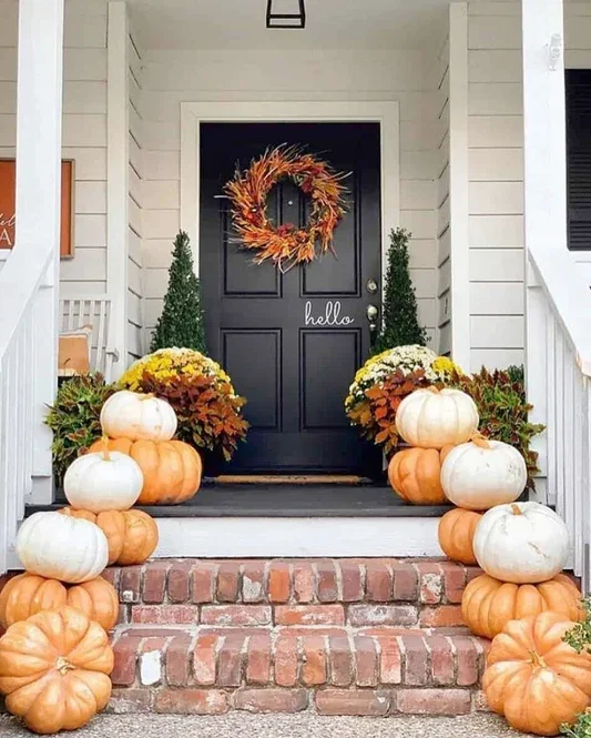 Cozy front porch decorated with pumpkins creating a warm and spooky autumn atmosphere