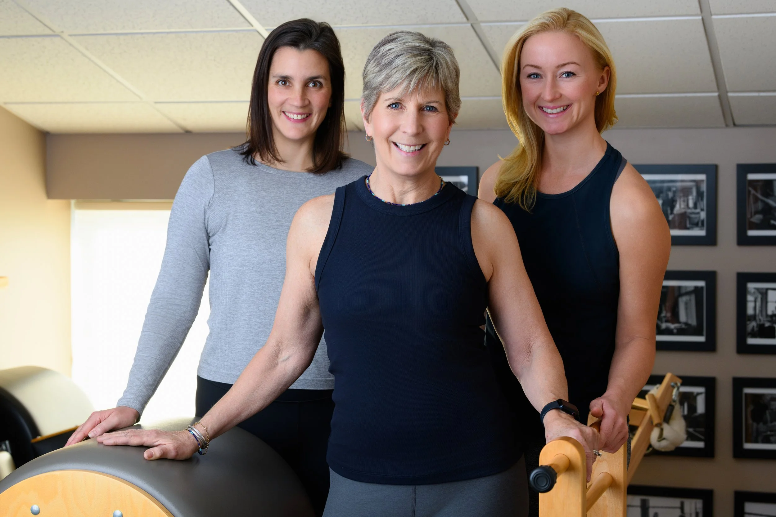 Jessica, Maureen, and Jane smiling together in the Authentic Pilates studio