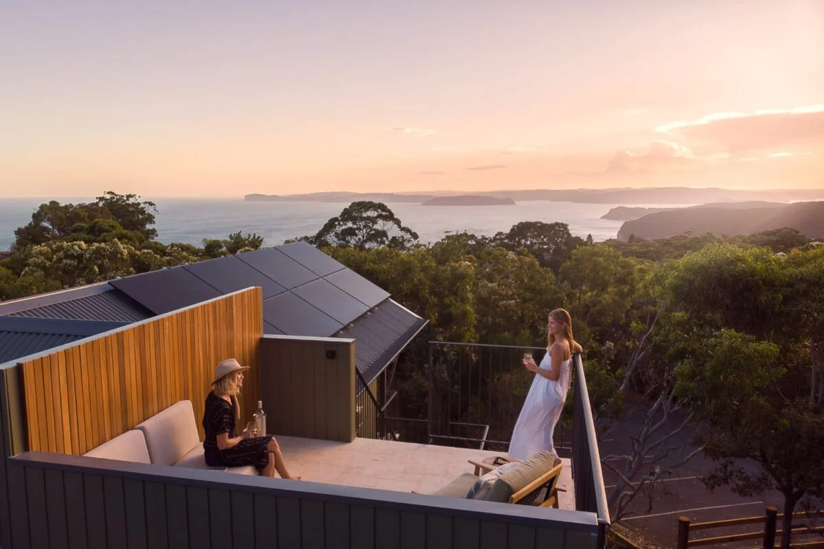 two women at sunset on rooftop deck