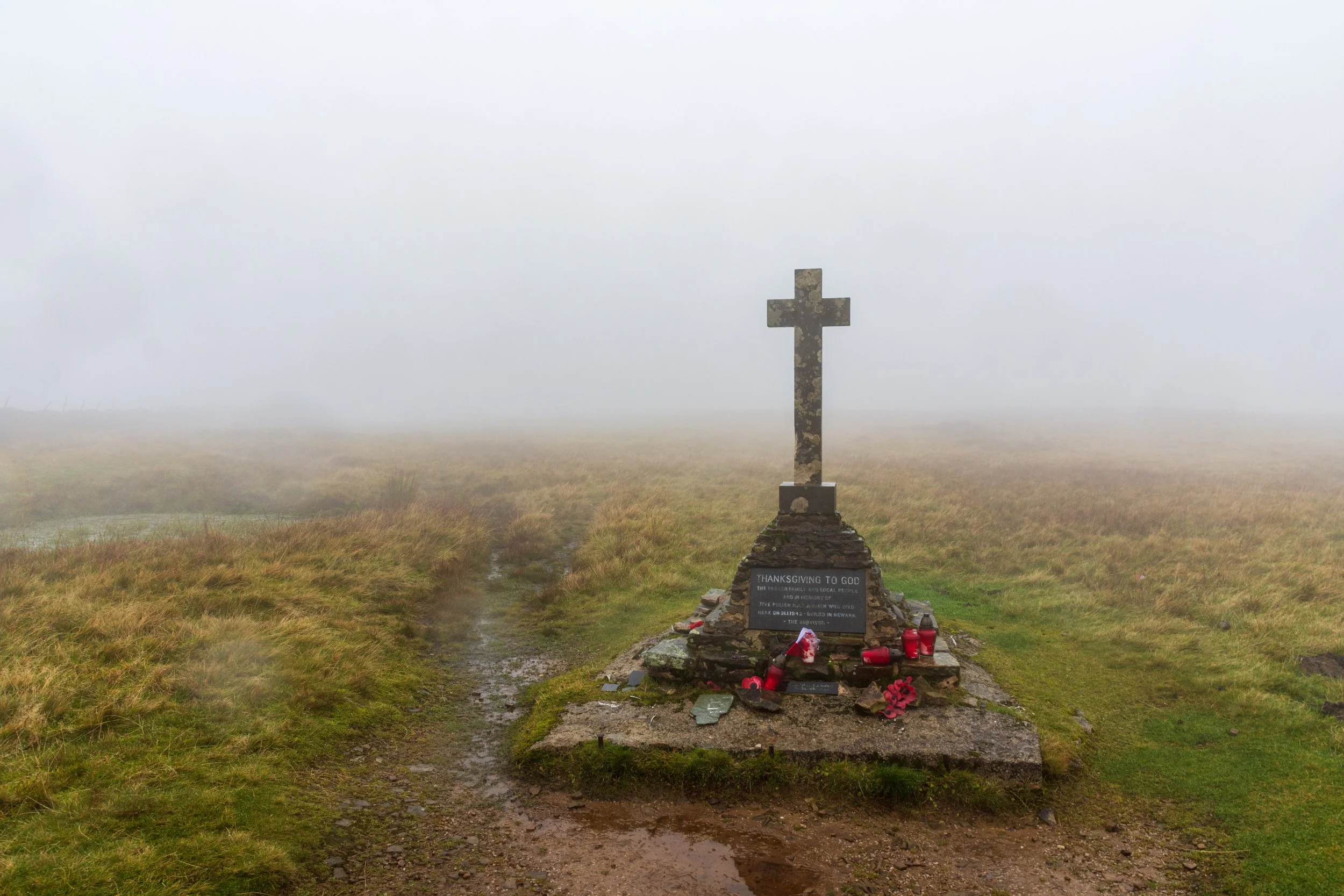The memorial cross on the summit of Buckden Pike, shrouded in mist