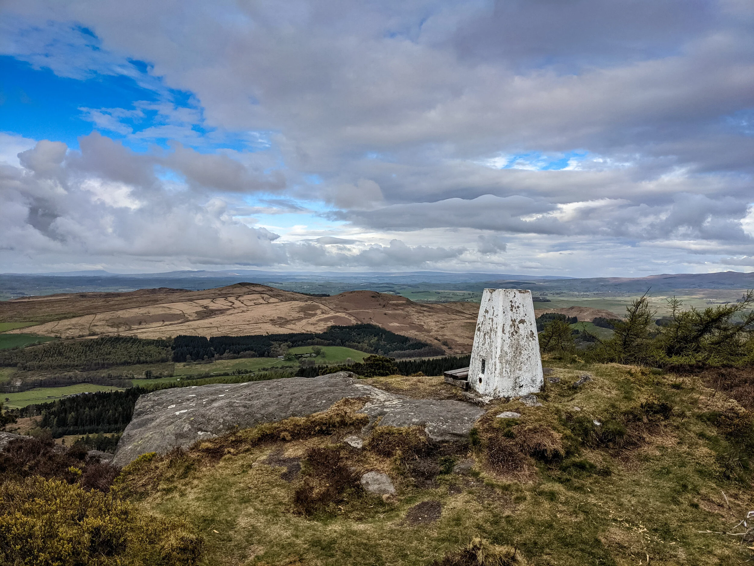 The trig point on Coockrise Crags near Cracoe Fell, looking towards Shap Haw and Rough Haw