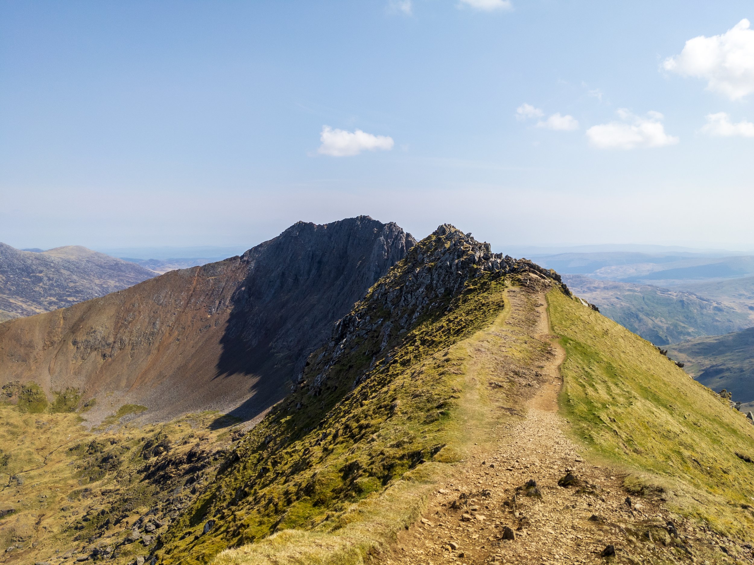 A photo of the imposing Crib Goch mountain and ridge on a beautiful, sunny day
