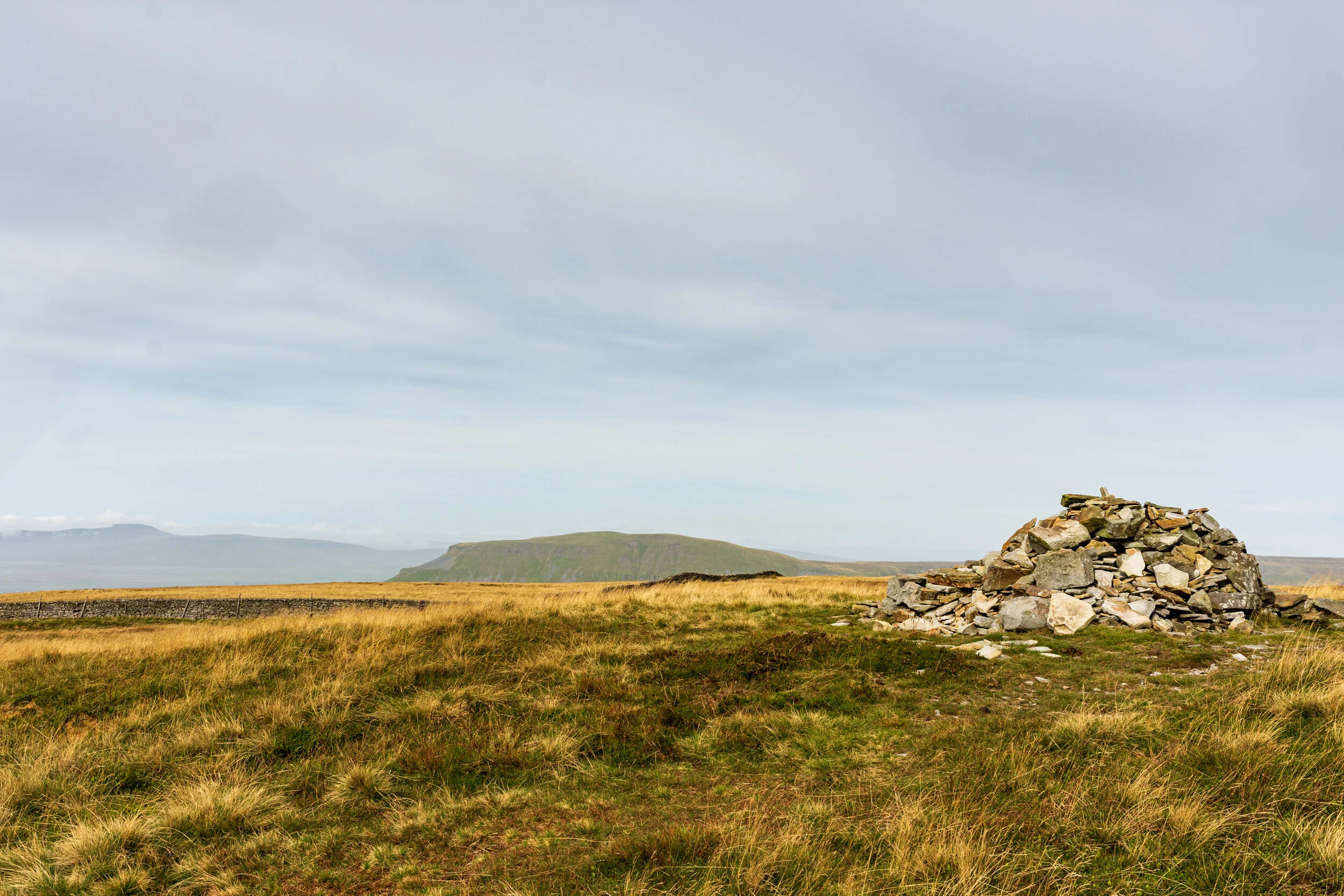 The summit of Fountains Fell, with Pen-y-Ghent and Ingleborough in the background