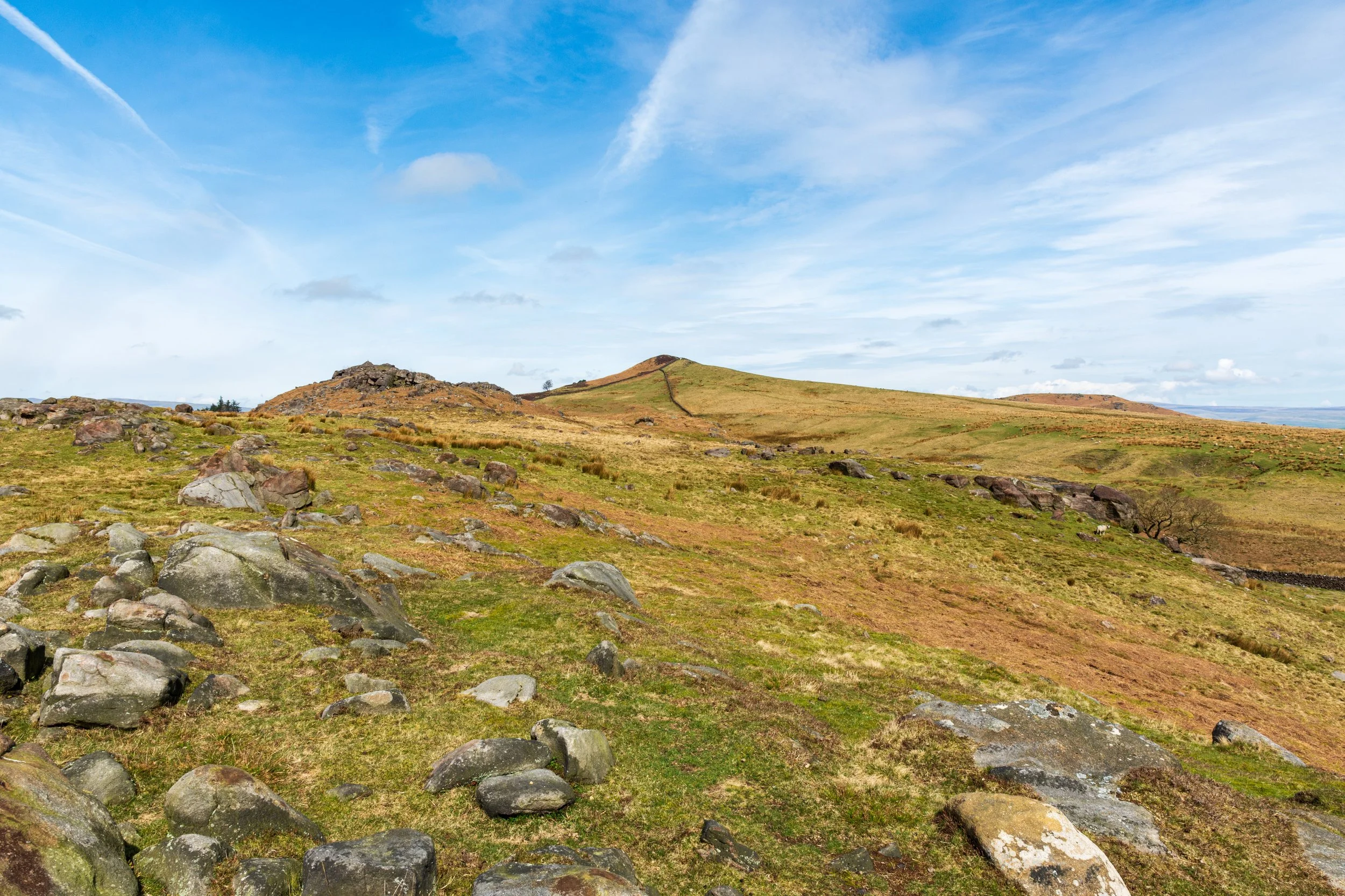 Three rocky summits in the Yorkshire Dales on a sunny day - an unnamed cairn, Sharp Haw and Rough Haw