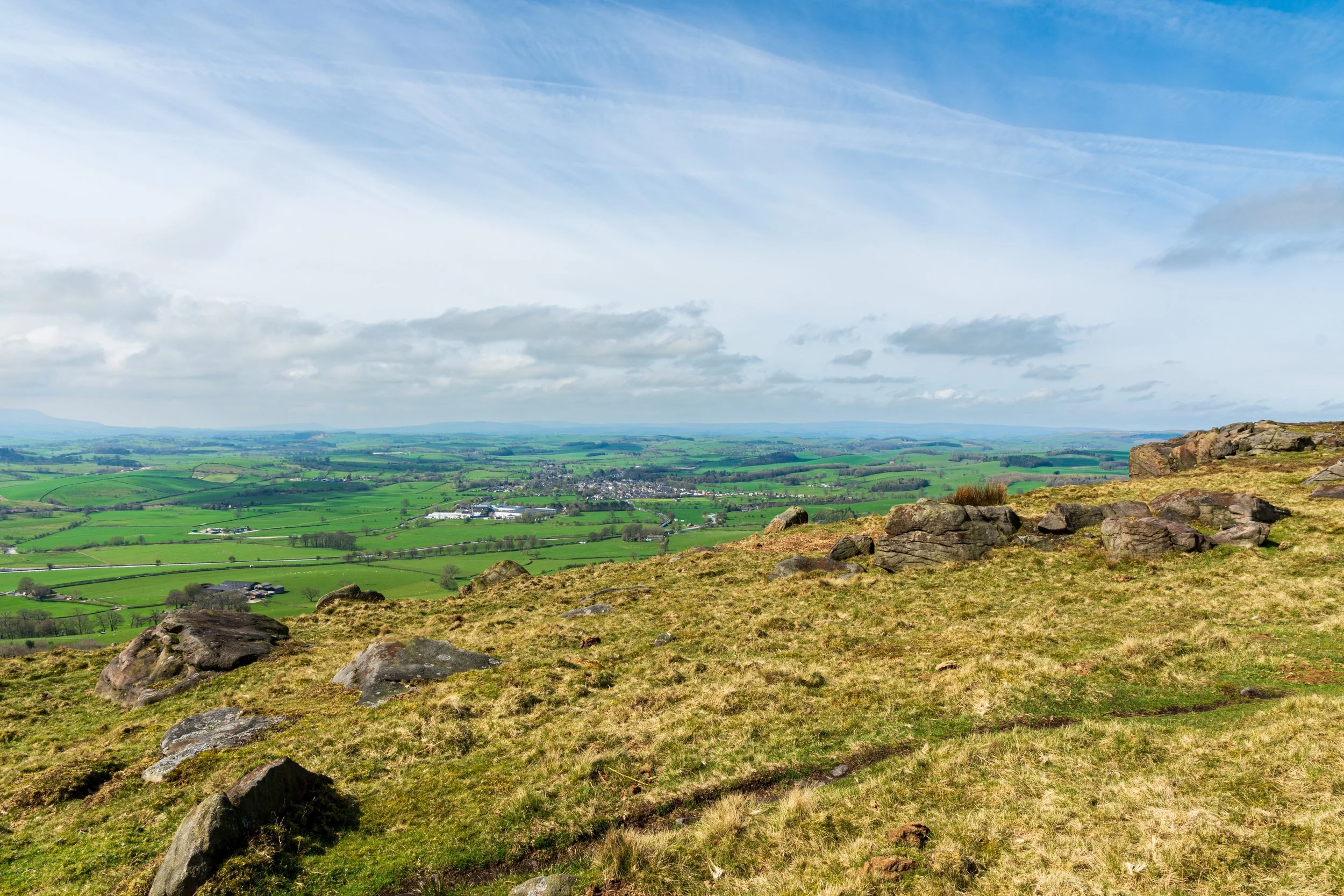 Looking out into the verdant Upper Aire Valley on a sunny day, from an unnamed summit near Sharp Haw. Gargrave is in the centre, and Pendle Hill is off to the far left