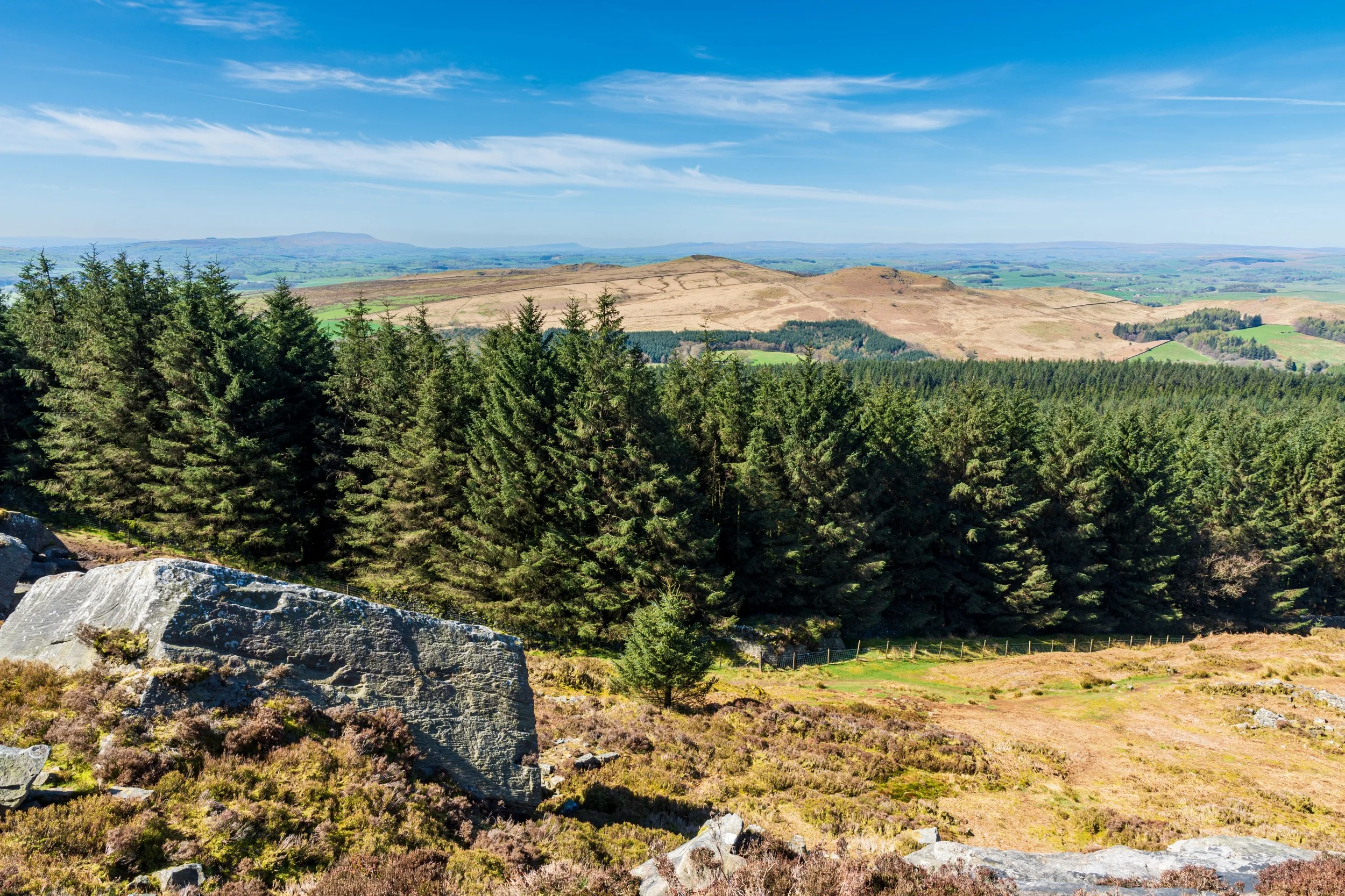 The barren but shapely hills of Sharp Haw and Rough Haw in the Yorkshire Dales, viewed from Cracoe Fell, with Pendle Hill in the background