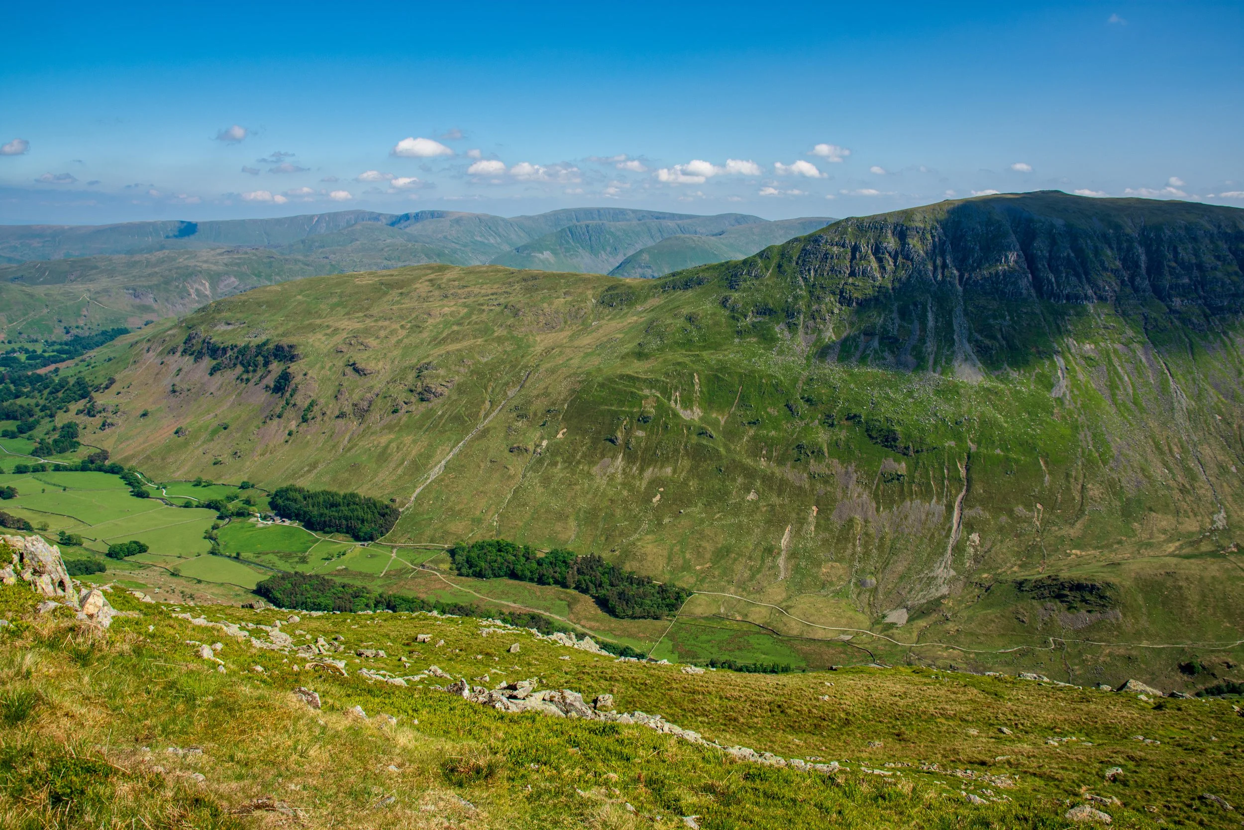 The mountain of St Sunday Crag in the Lake District, looking verdant on a clear sunny day, viewed from Striding Edge