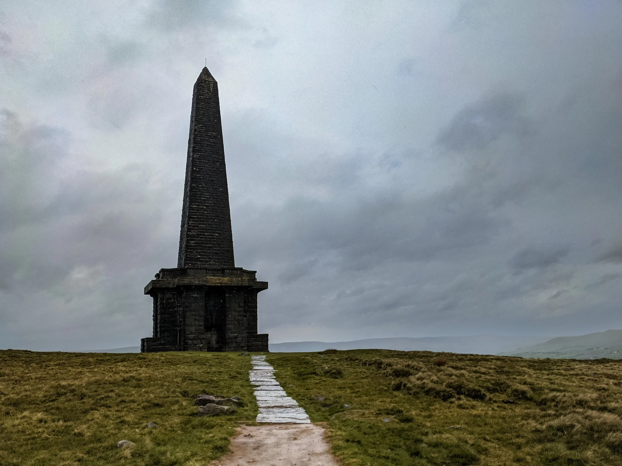 The dramatic monument towering above the summit of Stoodley Pike, on a cloudy and wet day