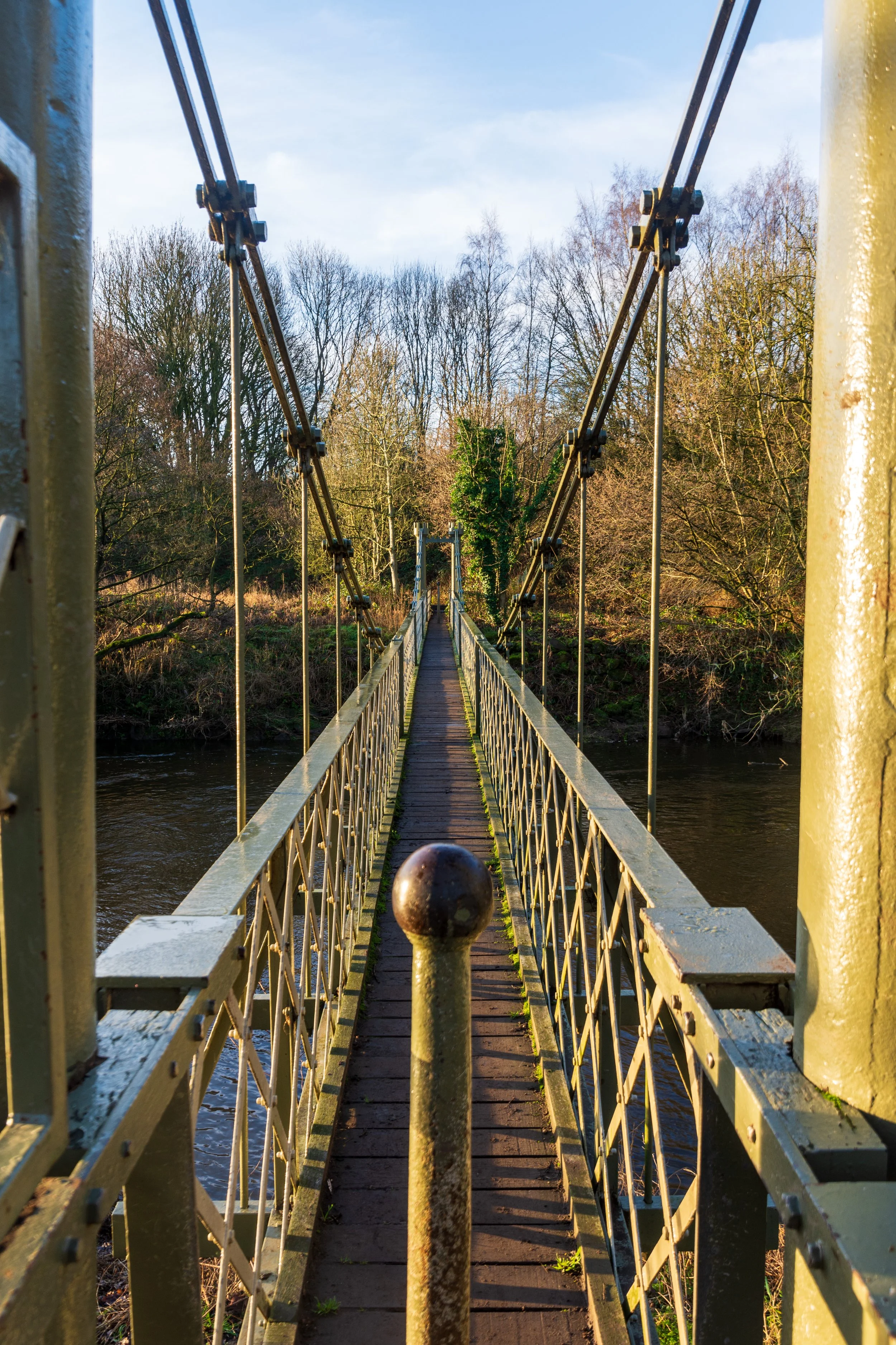 A suspension footbridge, crossing the River Aire, on a beautiful winter morning in West Leeds