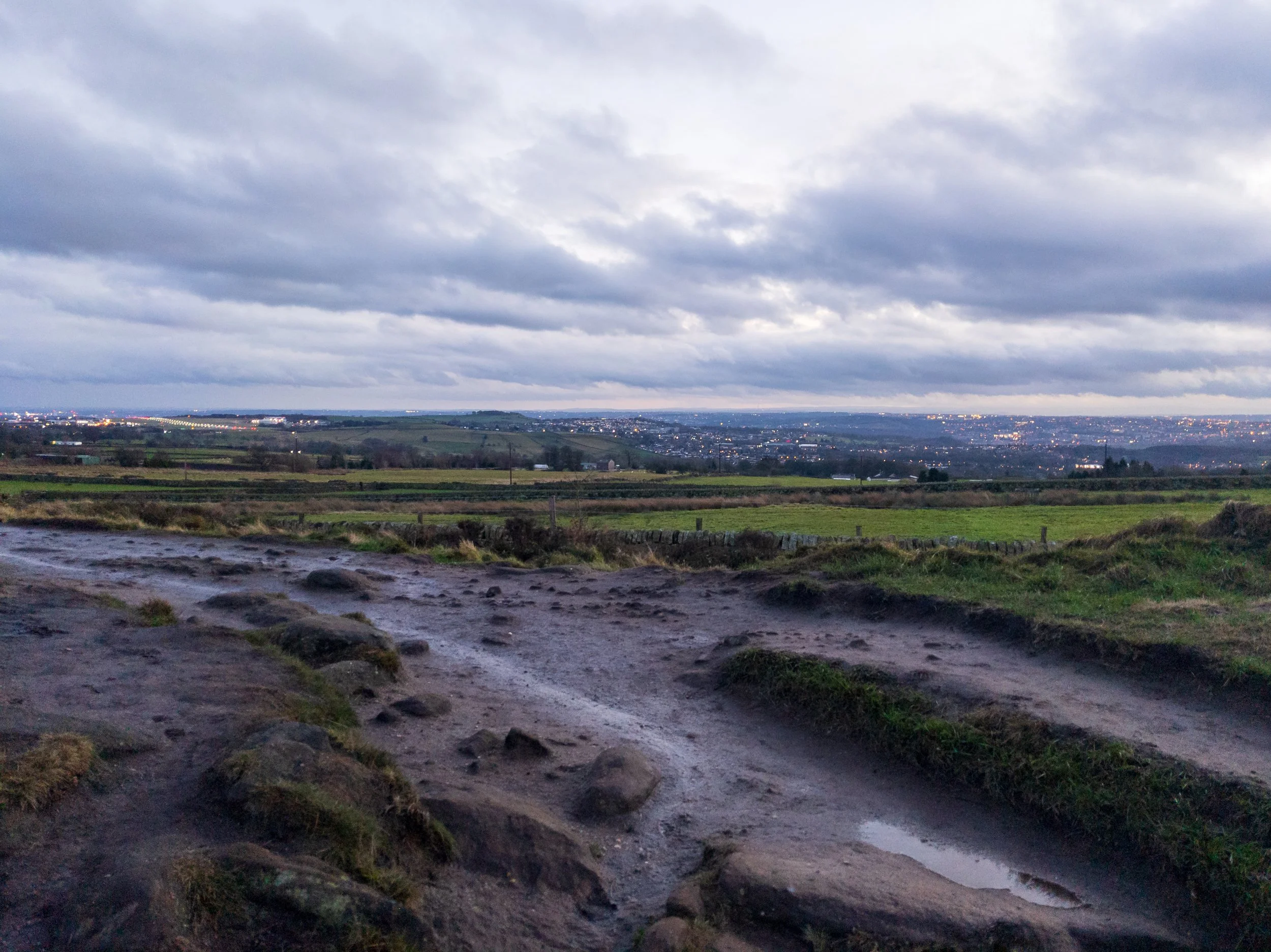 View of West Leeds and Leeds Bradford Airport (LBA) from Otley Chevin, taken near sunset on a stormy day
