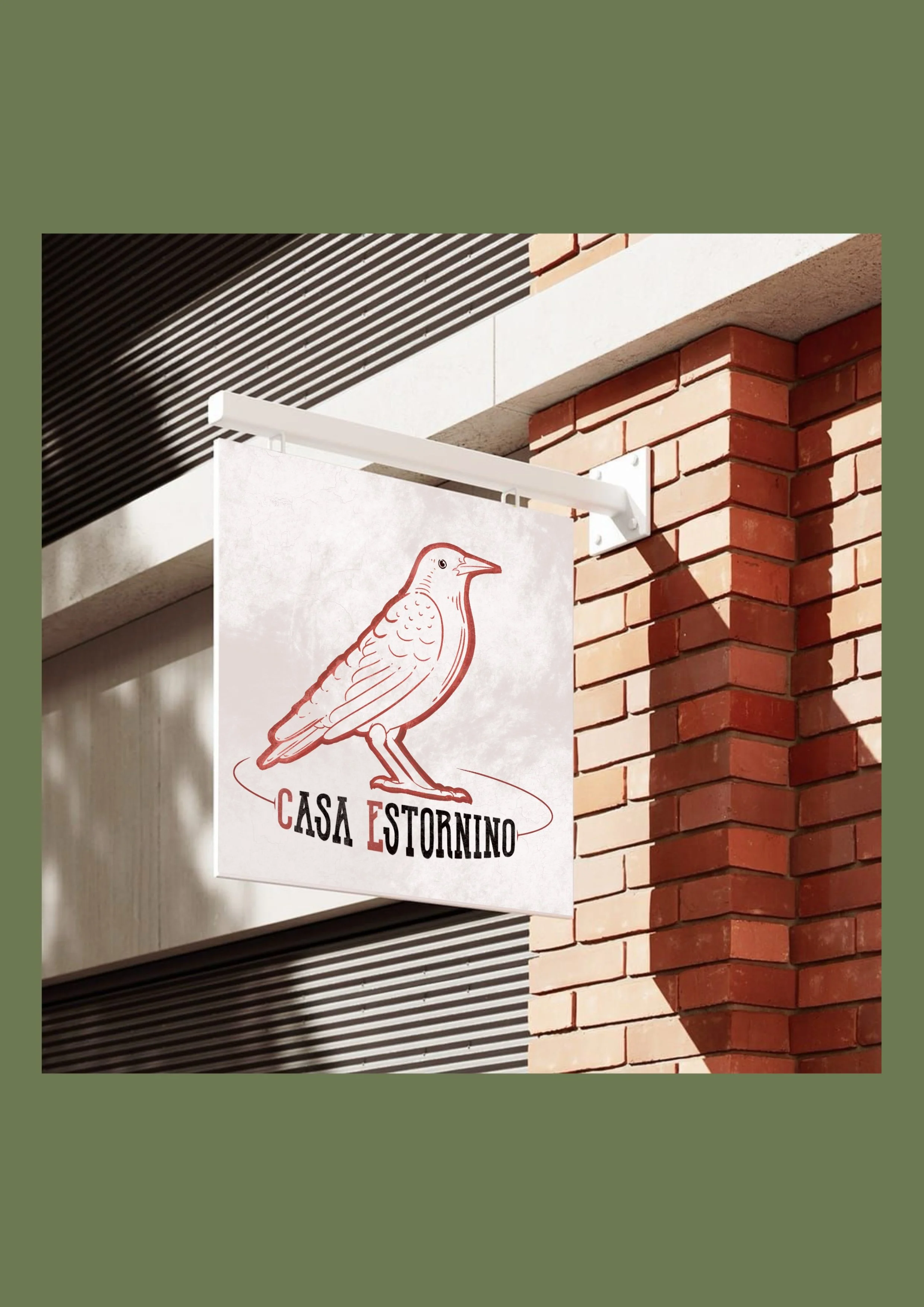 Sign with a drawing of a bird and the text "Casa Estornino" hanging outside a brick building.
