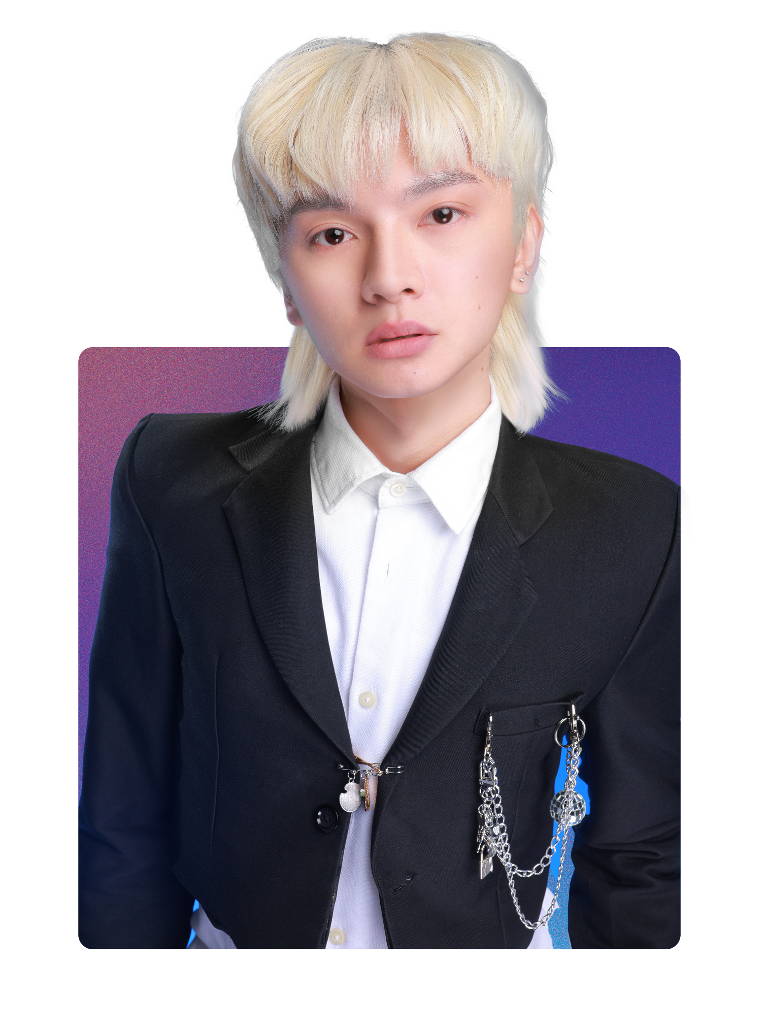A young person with platinum blonde hair wearing a black blazer with chains and a white collared shirt.