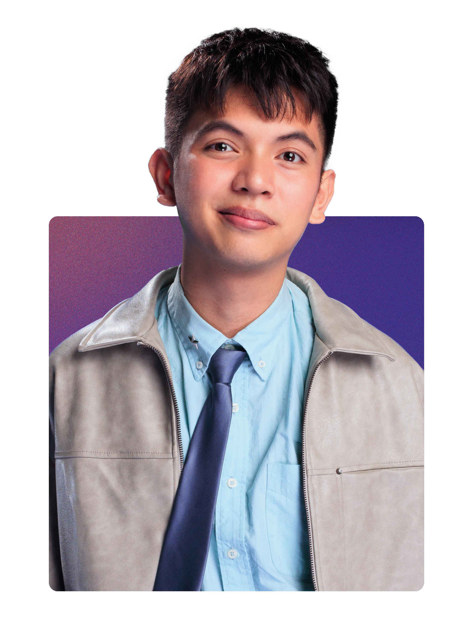 Portrait of a young man with dark hair, wearing a light blue shirt, navy tie, and beige jacket, smiling against a purple background.
