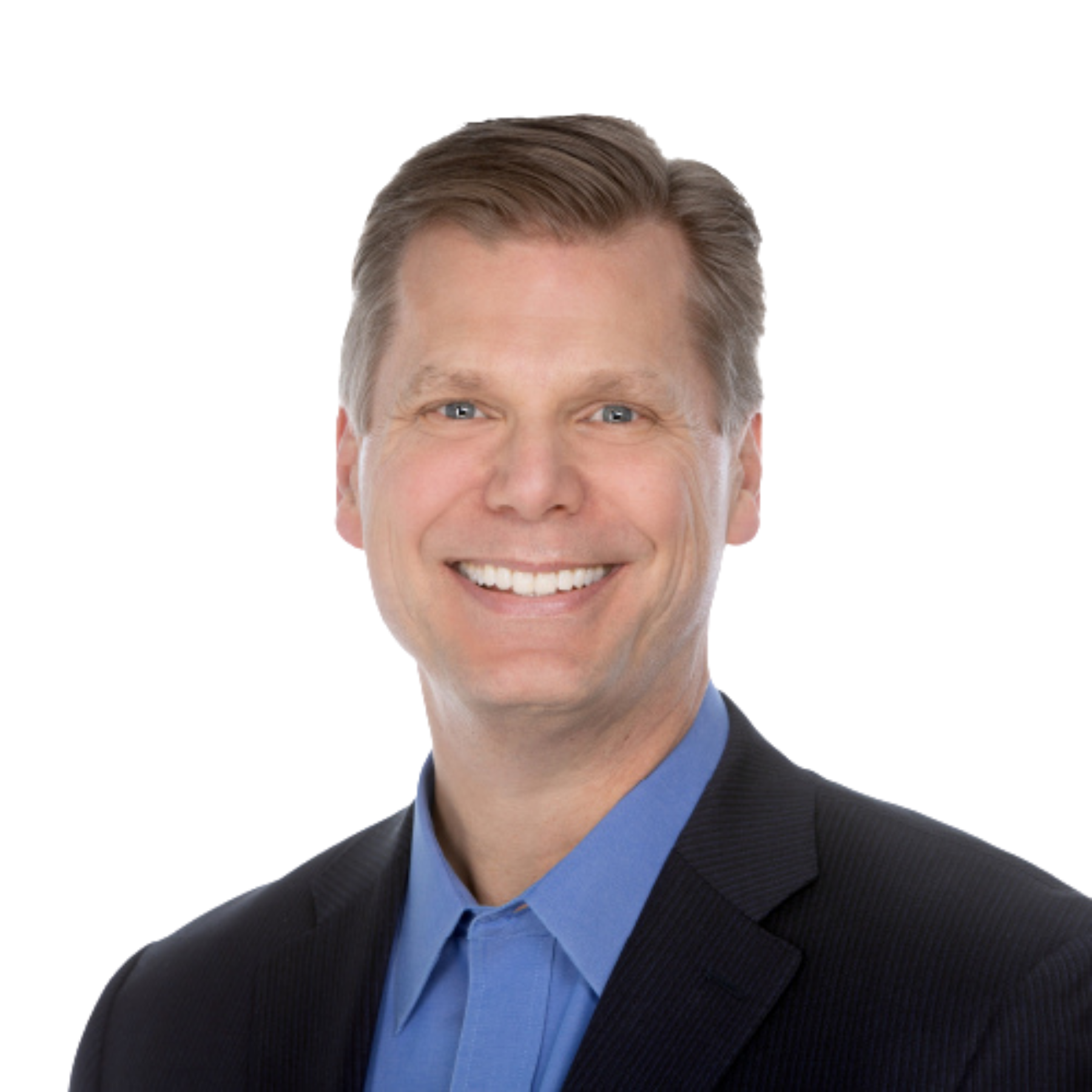 A smiling man wearing a dark business suit and a blue shirt.
