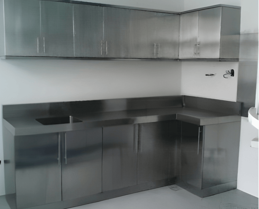 Stainless steel kitchen cabinets and countertop with an embedded sink in a modern kitchen.