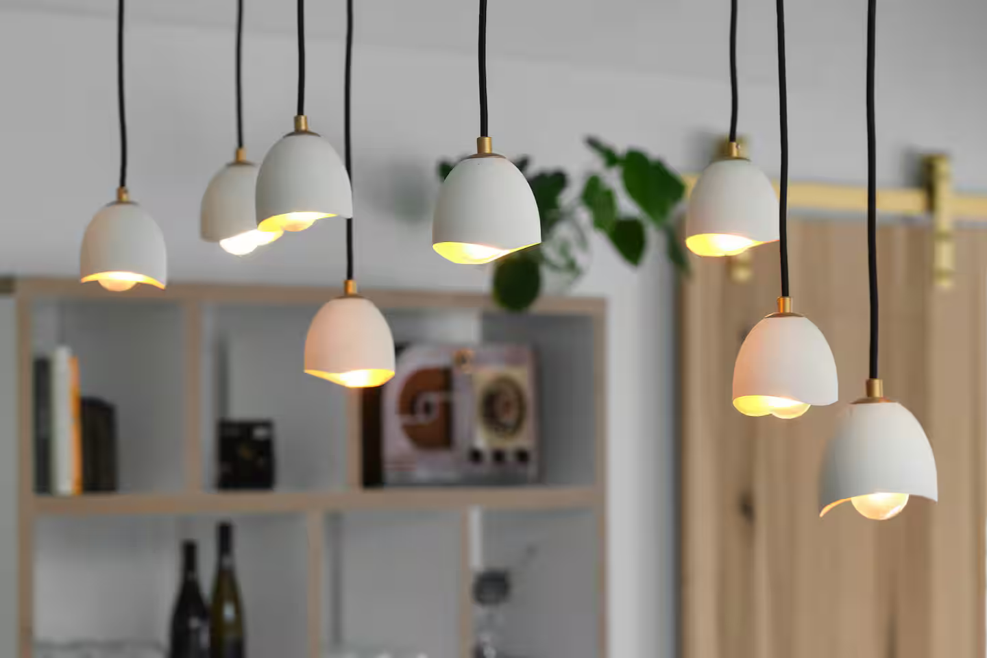 Modern pendant light fixtures hanging from the ceiling in a contemporary interior space.