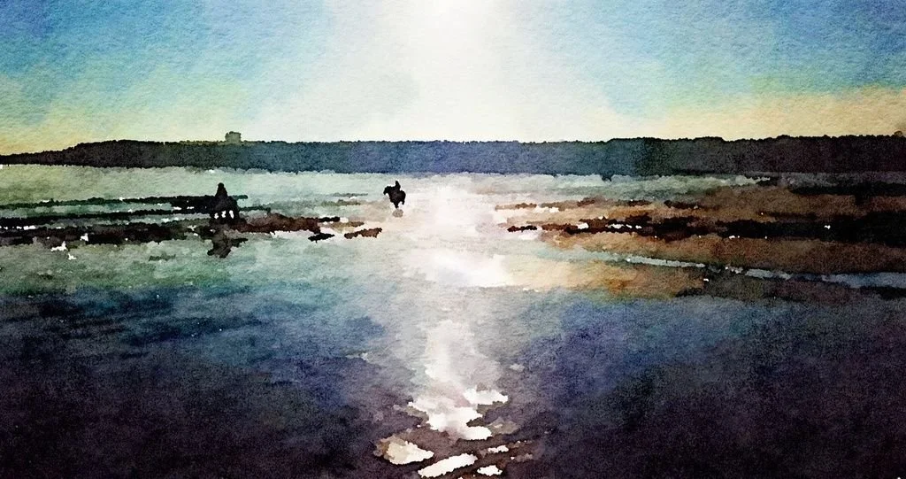 Silhouettes of two people walking on a beach during sunset, with the sky and water reflecting warm colors.