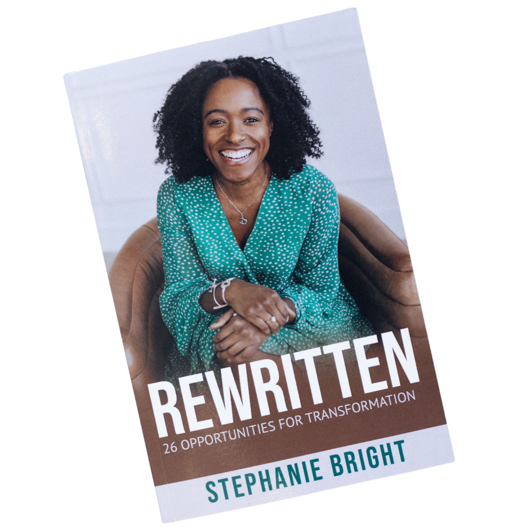 Book cover titled "Rewritten: 26 Opportunities for Transformation" by Stephanie Bright, featuring a smiling woman with curly hair wearing a green polka dot dress on a brown chair.