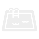 A swimming pool with a small pool toy floating on the water.