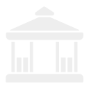 A white, classical-style building with columns and a triangular pediment, resembling a government or historical structure.