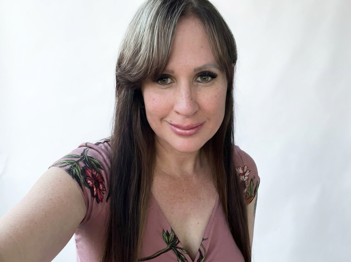 Portrait of stylist Amber at Hair Unlimited Salon in Jacksonville Florida, specializing in perms and professional hair straightening treatments.