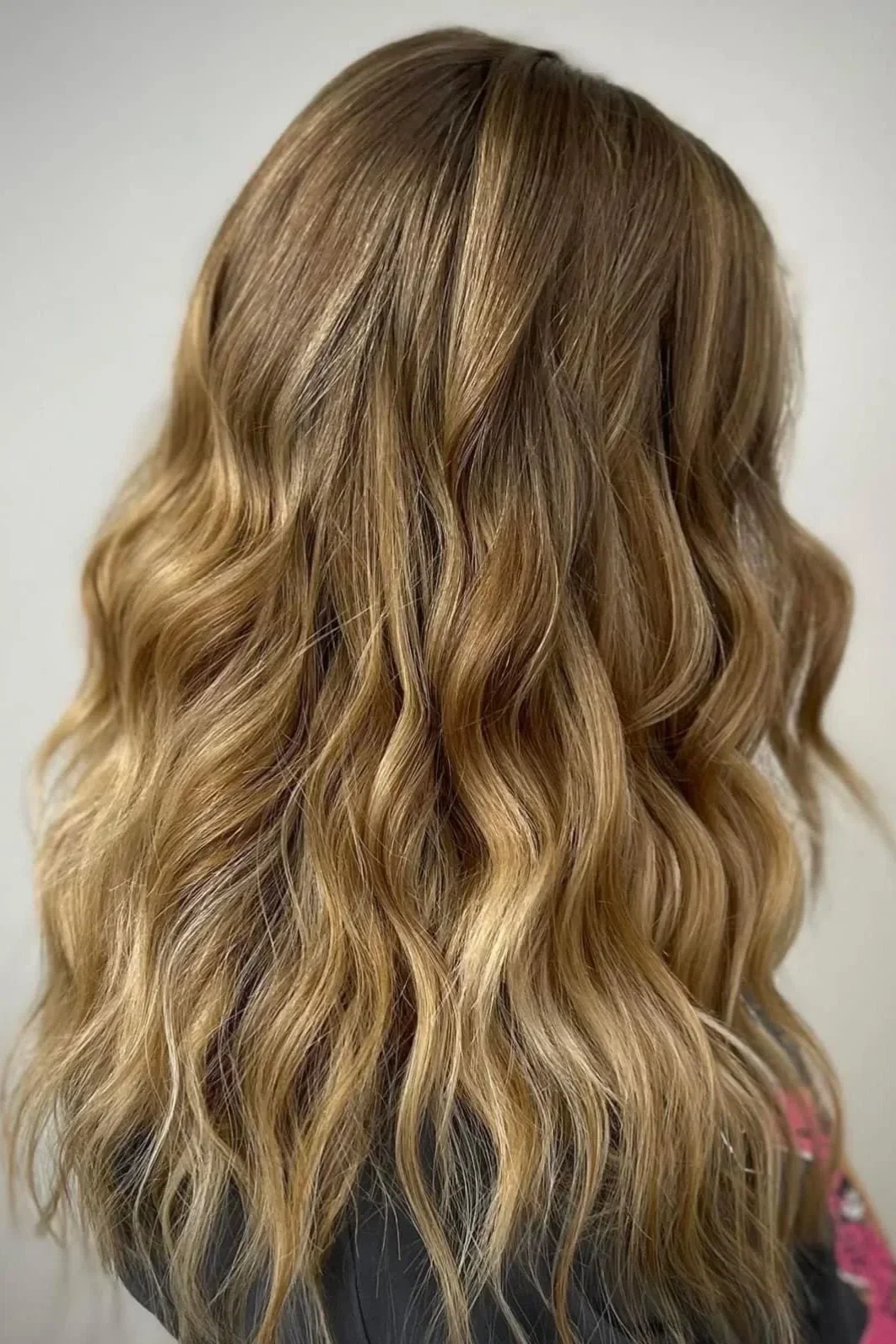 Close-up of wavy, blonde hair with highlights.