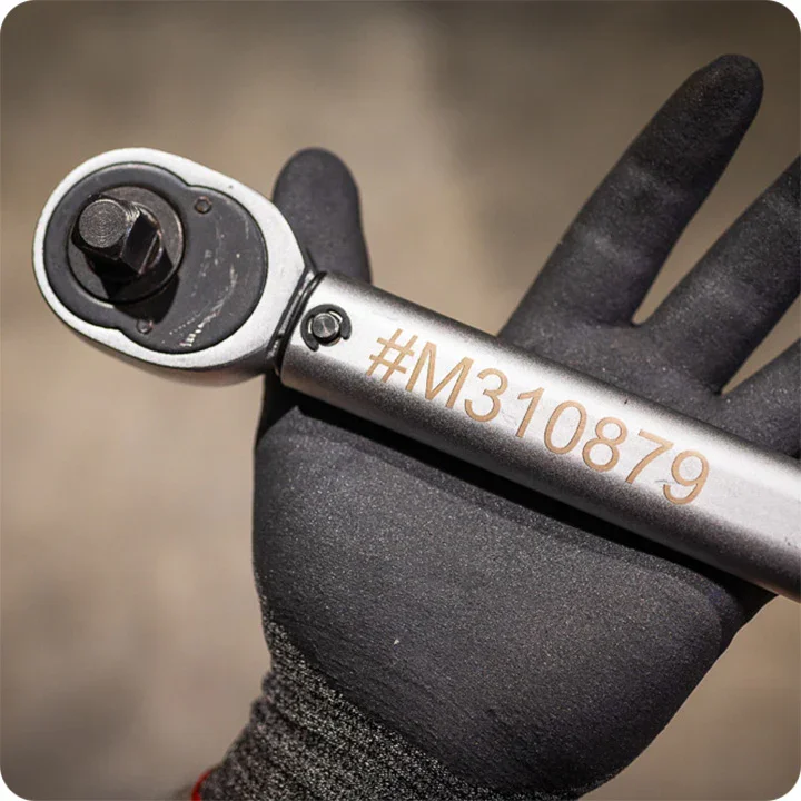 Palm open with wrench that is etched with laser