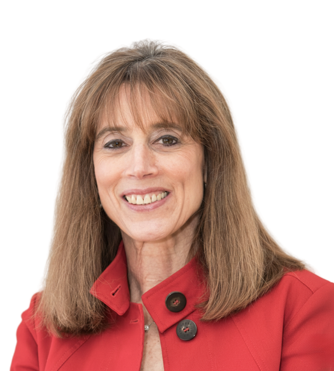 A woman with shoulder-length light brown hair wearing a red blazer with large black buttons, smiling against a white background.