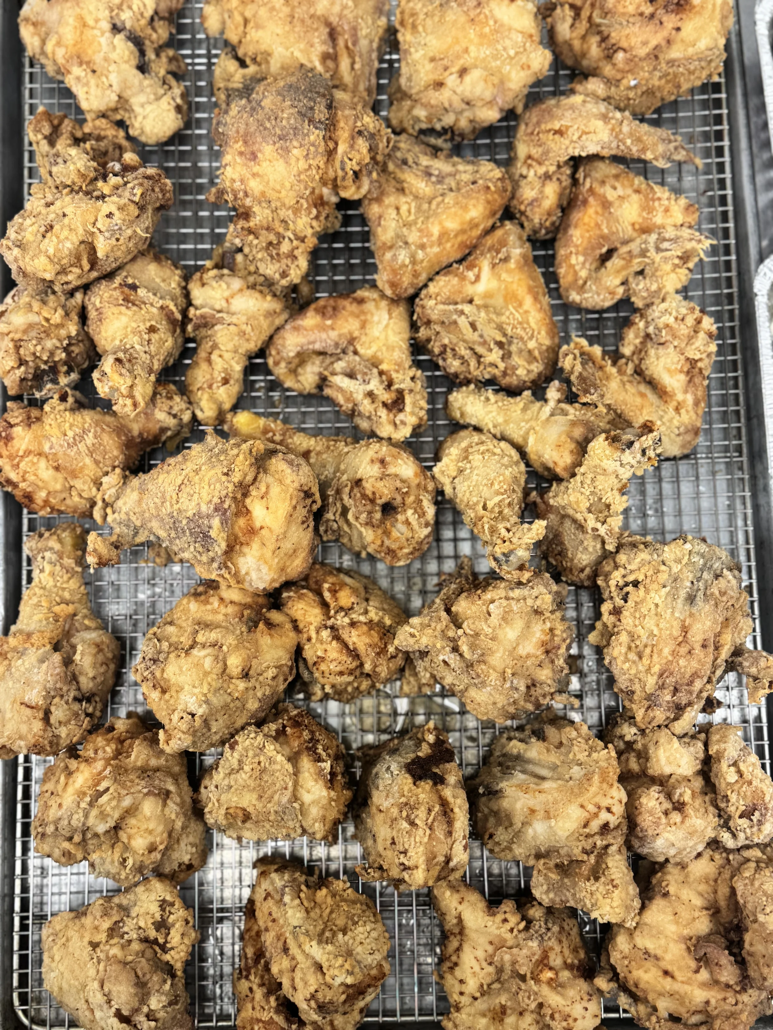 Fried chicken pieces on a wire rack