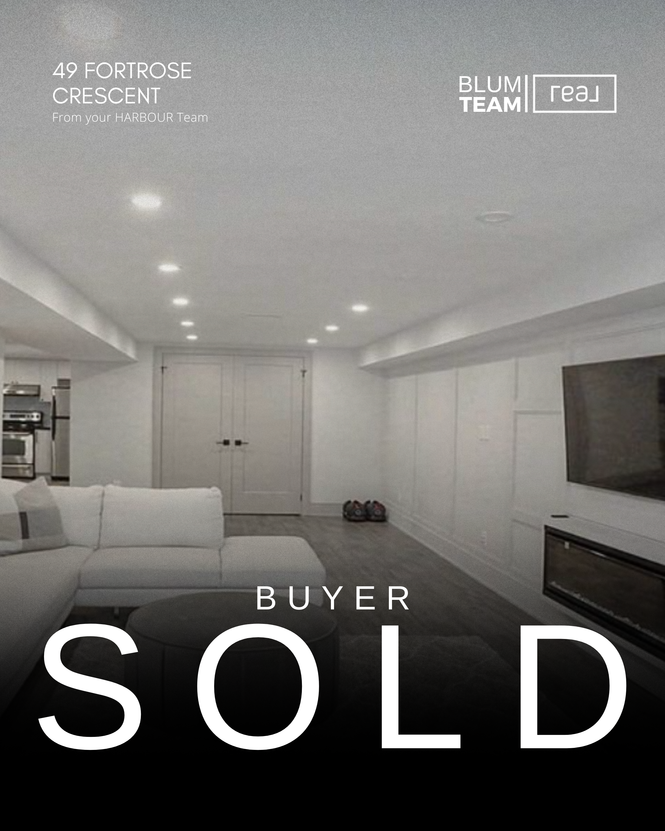 Interior view of a modern living room with white walls and ceiling, a white sofa, a black round coffee table, and a large flat-screen TV. The room has a door at the back and a pair of shoes on the floor. Text overlay indicates the property address, agent team, and the status 'Sold'.