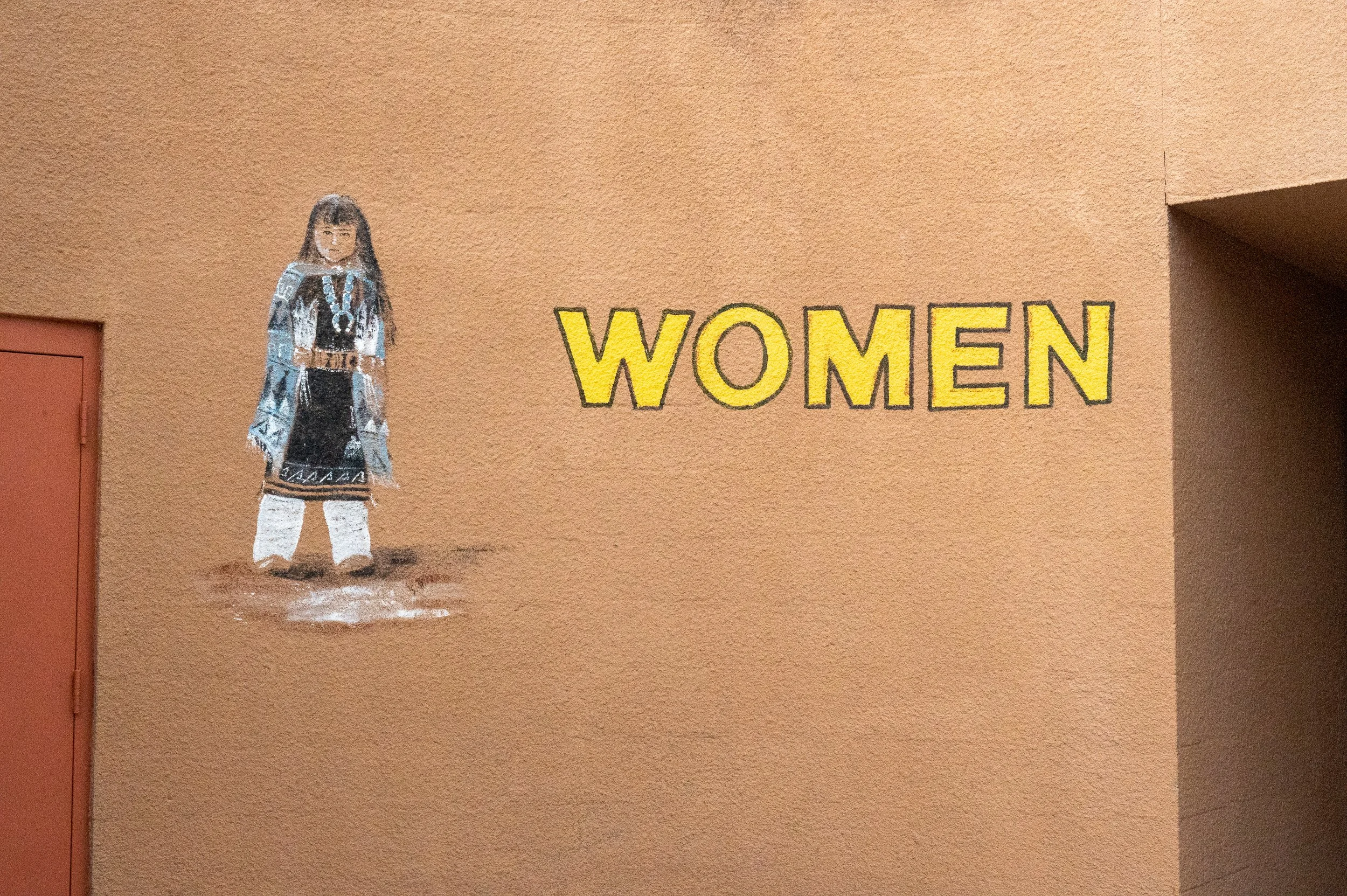 Sign for women in traditional American Indian dress