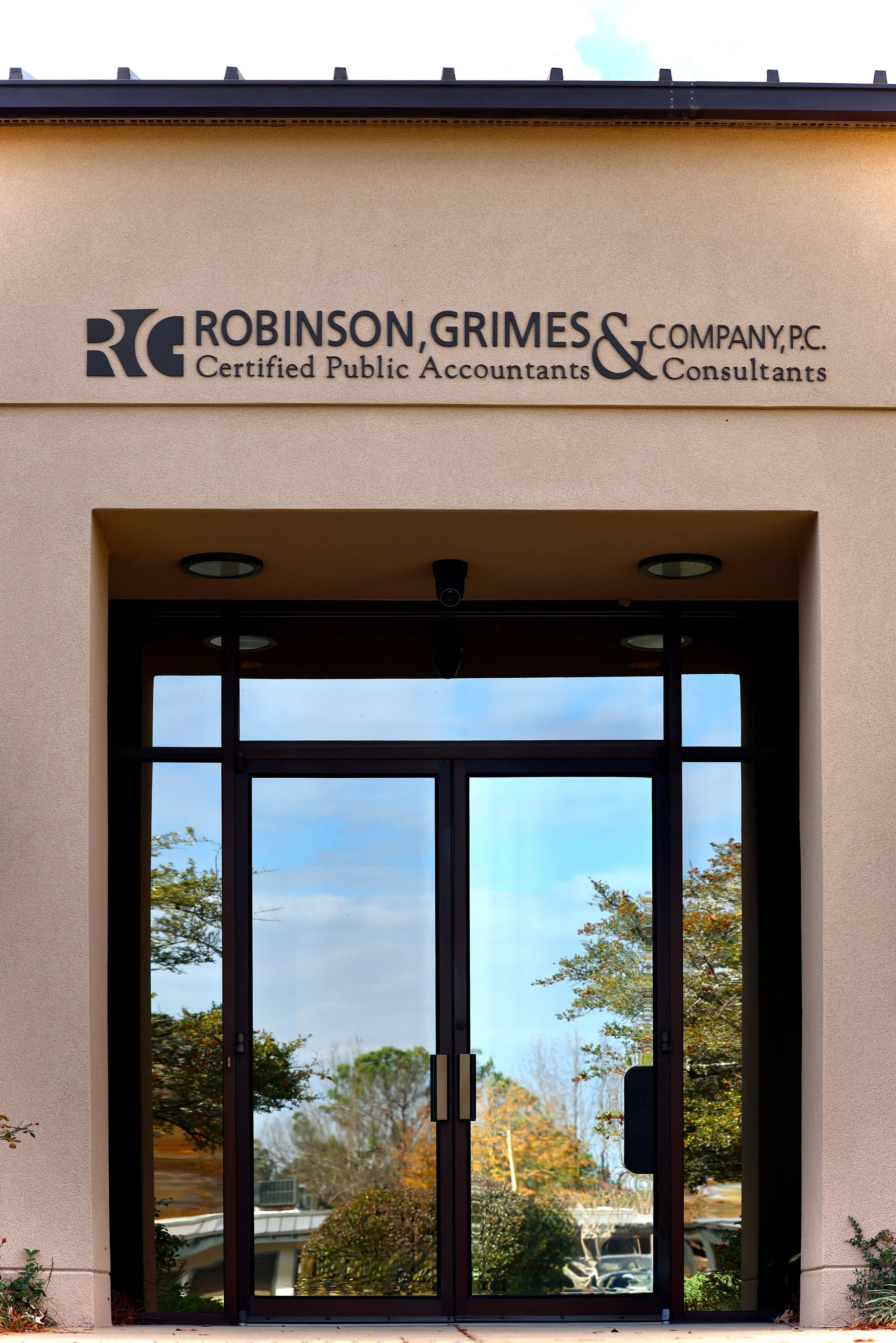 Entrance of Robinson, Grimes & Company, P.C., Certified Public Accountants and Consultants office with glass door and company signage.