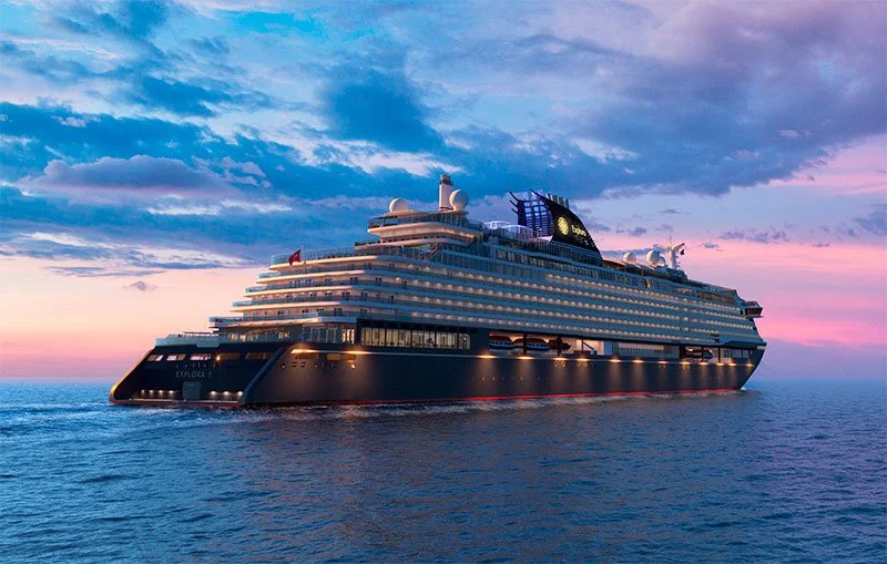 A large luxury cruise ship, Explora II, sailing across calm ocean waters at sunset beneath a colorful sky — an elegant reflection of slow travel, refined design, and effortless ocean exploration.