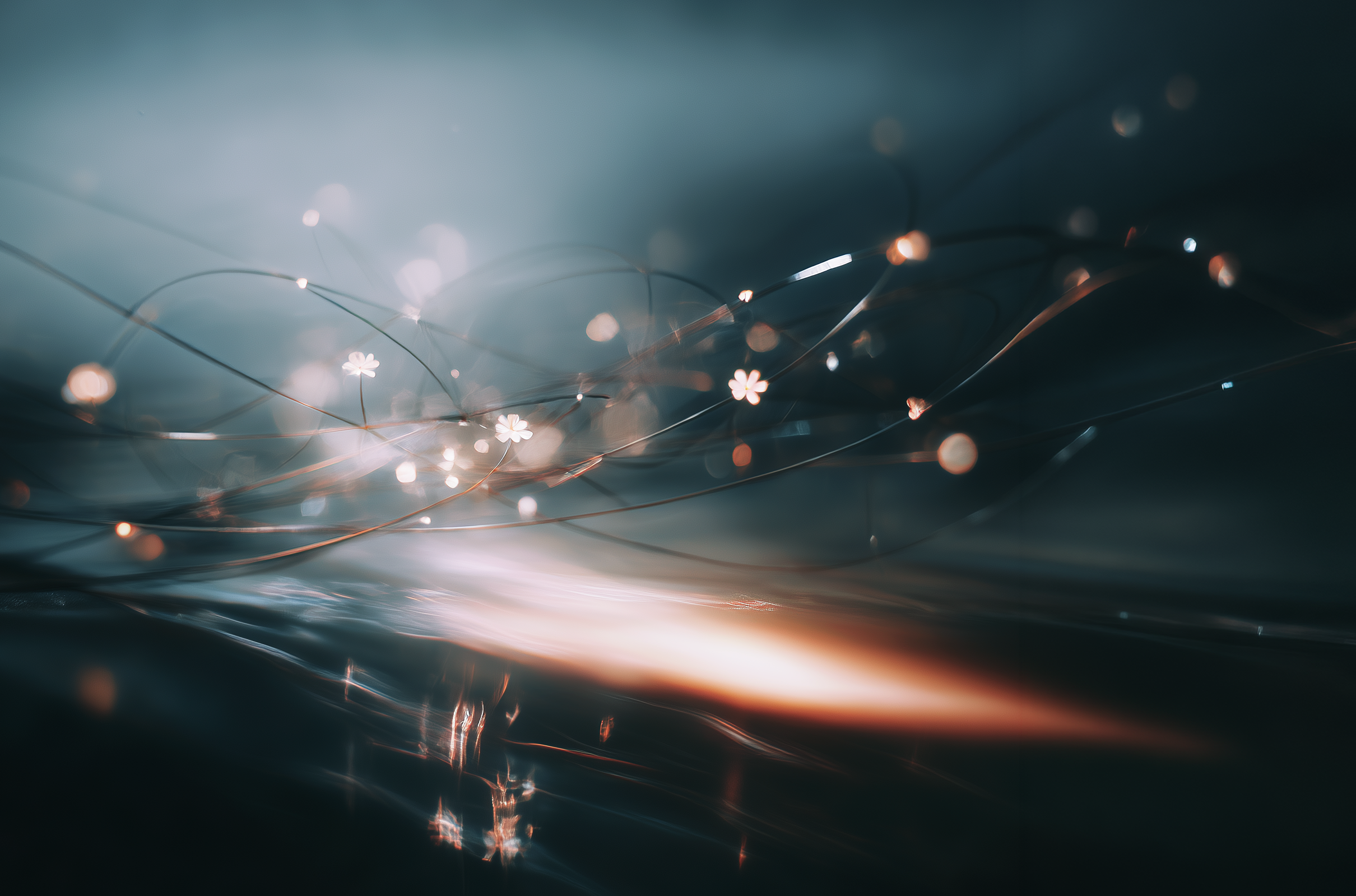 Fine glowing lines and soft points of light sweep across a dark blue surface, forming an abstract network with subtle reflections.