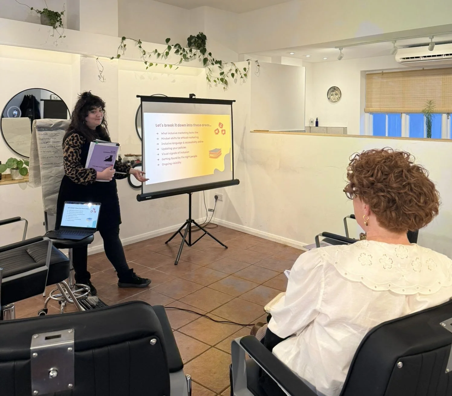 Educator leading a Neurodiversity in the Salon training session at Salon Spectrum, teaching hairstylists about inclusive marketing, communication, and accessibility practices.