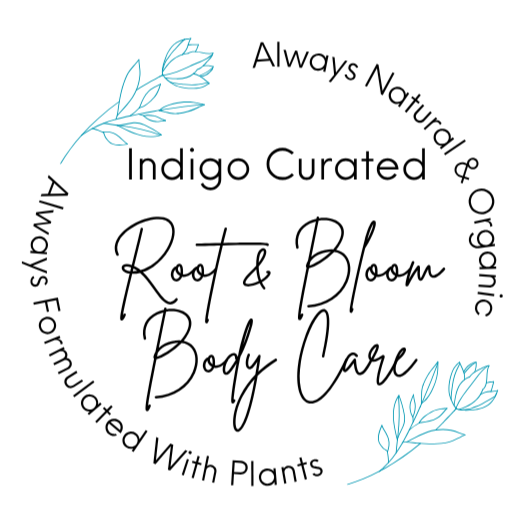 Circular logo with blue leaves on top left and bottom right, black text reading "Always Natural & Organic," "Indigo Curated," and "Root & Bloom Body Care," with "Root & Bloom" in cursive and the rest in a sans-serif font.